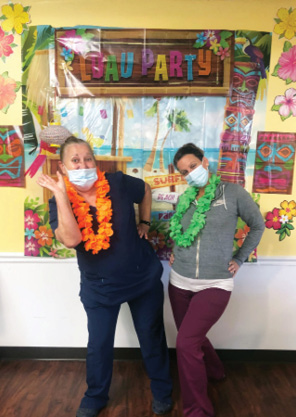 Twin Rivers Nursing and Rehab staff members dressed for luau party
