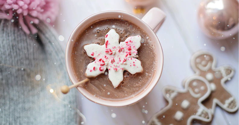 Top view of a cup of hot chocolate in a mug with peppermint candy on top