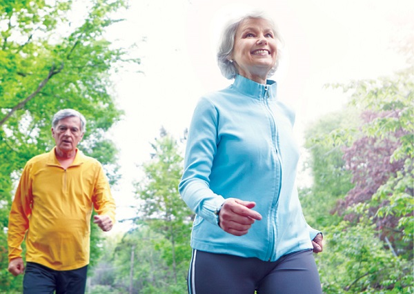 older adult woman and man jogging in the park