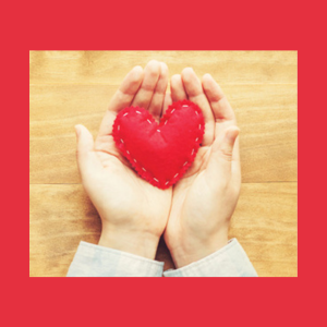 cupped hands holding a red felt heart