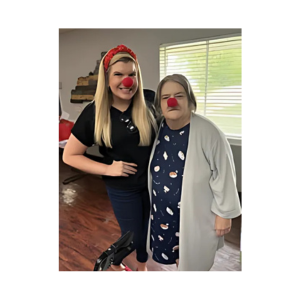 Twin Rivers Nursing and Rehab resident, Mary, pictured with staff member. Both wearing Red clown noses